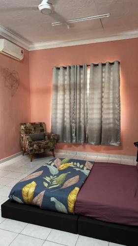 a bedroom with a large bed in front of a window at LOT 1423 Homestay Lonek-Batu Kikir in Bahau