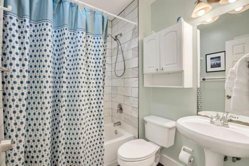 a bathroom with a toilet and a sink and a shower at Tybee Turtle in Tybee Island