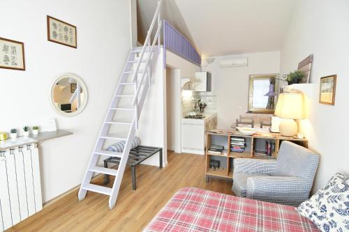 a room with a staircase and a living room at Alla Cantina in Aurisina Case