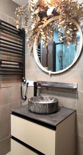 a bathroom with a stone sink and a mirror at La Terraza de La Línea in La Línea de la Concepción