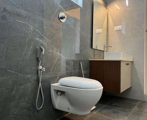 a bathroom with a toilet and a shower at Bison Trails Valley View Kothagiri Ooty Tamilnadu in Kotagiri