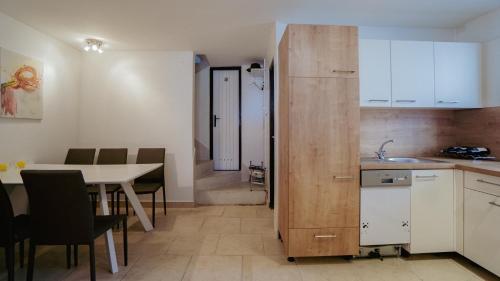 a kitchen and dining room with a table and a table and chairs at MareVita in Tribunj