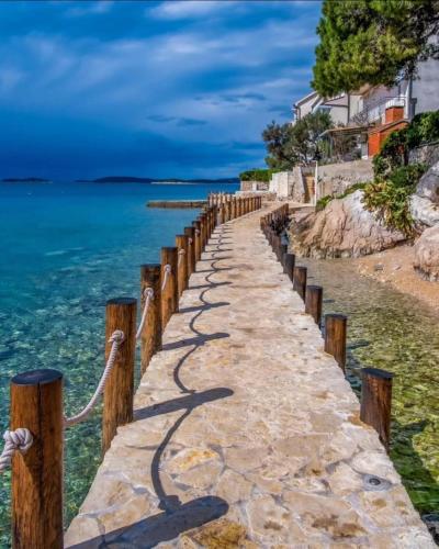 a walkway over the water on a beach at MareVita in Tribunj