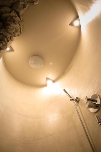 a bathroom with a circular ceiling with lights on it at BergQuell in Tannheim