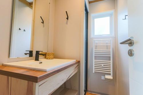 a bathroom with a sink and a mirror at Camping la Croix du Sud in Ramatuelle