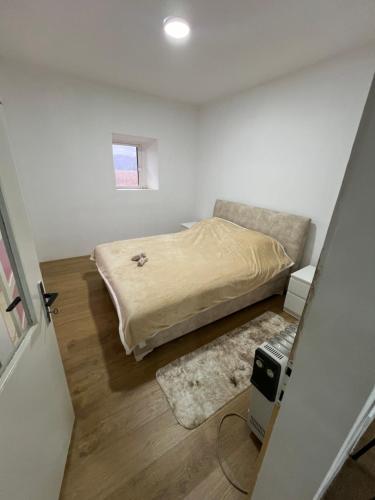 a small bedroom with a bed and a rug at Skadar Lake Stone House in Podgorica