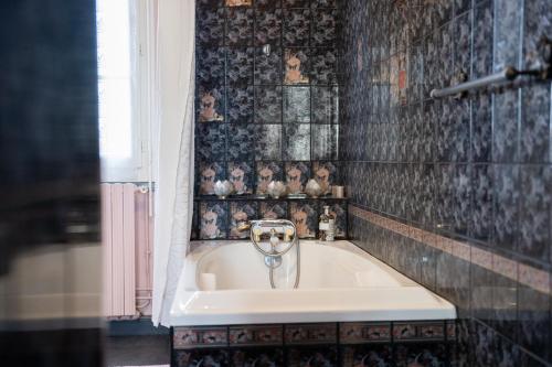 a bathroom with a bath tub with a sink at La Maison Coloniale - 15 Personnes - Piscine in Artagnan