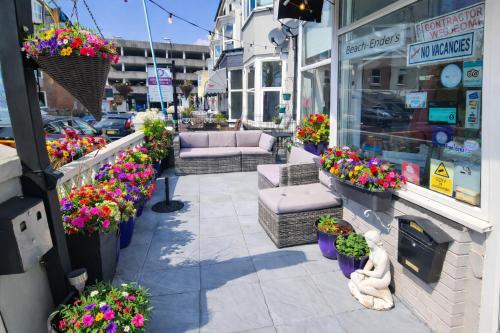 a flower shop with couches and flowers on a street at The Roslyn Guest House in Paignton