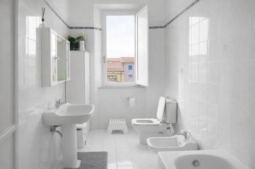 a white bathroom with two sinks and two toilets at Treehouse - Spacious Private Rooms in Central Pisa Near Station & Airport in Pisa