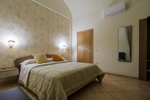 a bedroom with a bed and a tv on the wall at Domus Gargilius in Pompei