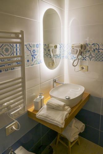a bathroom with a sink and a mirror at Domus Gargilius in Pompei