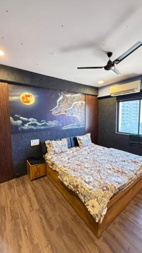 a bedroom with a bed with a painting on the wall at 7 Star Hotel in Surat