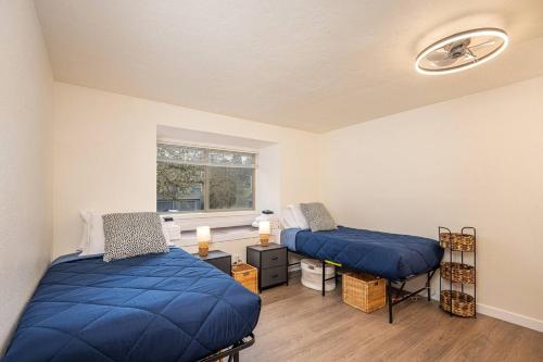 a room with two beds and a window at Cozy 3-Bedroom Townhome - 3 Miles from OSU! in Corvallis