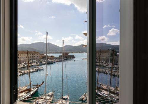 a view from a window of a harbor with boats at Perla Marina - HelloElba in Portoferraio