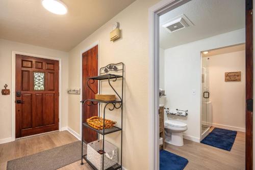 a bathroom with a toilet and a shelf at Cozy 3-Bedroom Townhome - 3 Miles from OSU! in Corvallis