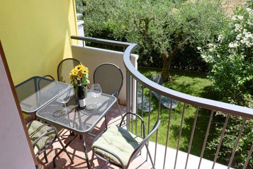 a balcony with a table and chairs on a patio at Casa Carla in Nago-Torbole