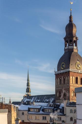 a building with a clock tower on top of it at Carillon Aparthotel - Keystone Collection, opened December 2025 in Riga