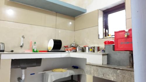 a kitchen with a sink and a counter top at Couples Nest in Kottakamboor