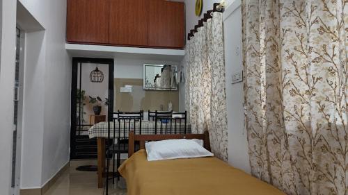 a bedroom with a bed and a dining room at Couples Nest in Kottakamboor