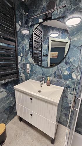 a bathroom with a sink and a mirror at W Ustce Lipa in Ustka