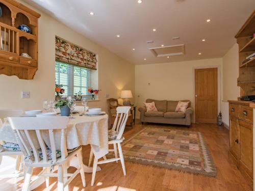 a kitchen and living room with a table and chairs at Freshwater Barn in Benenden