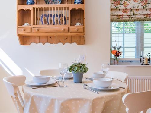 a dining room table with a white table cloth at Freshwater Barn in Benenden