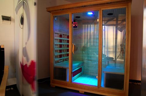 a glass cabinet with blue lights in a room at Hotel Centrale in Syracuse