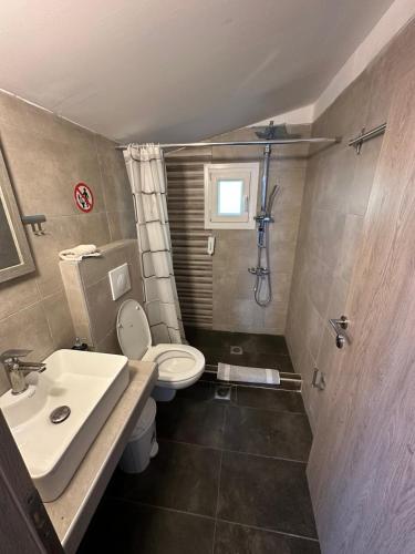 un bagno con lavandino, WC e doccia di F & R Villa a Perea