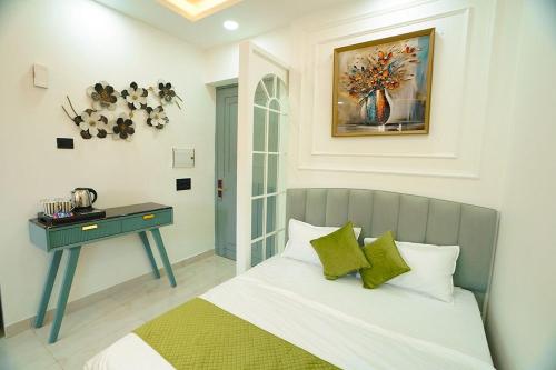 a bedroom with a bed with a table and a painting at Lux Lettings in Noida