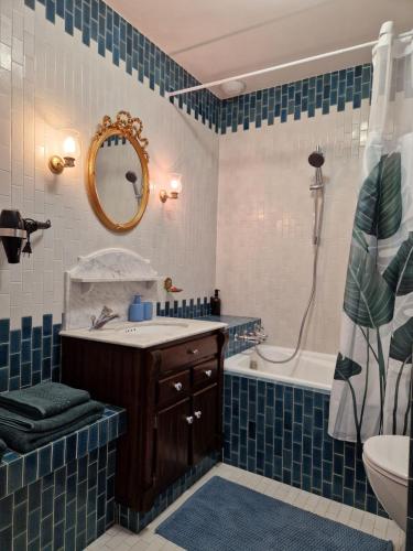 a bathroom with a tub and a sink and a mirror at Omah Jawa in Lourdes