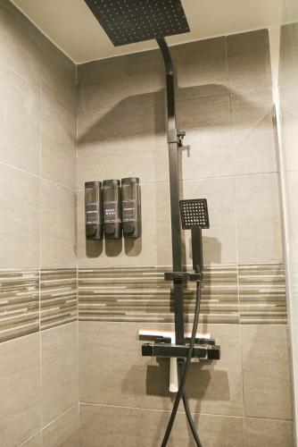 a shower in a bathroom with a glass shower stall at Suite CinéRoom à 25 min de Paris in Franconville