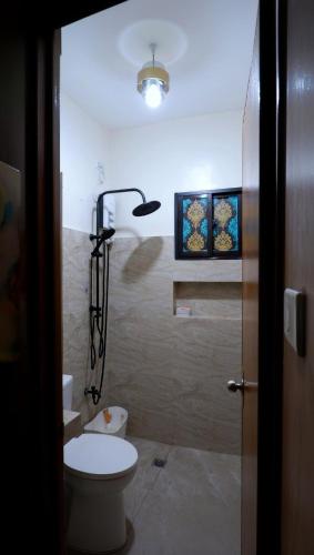 ein Badezimmer mit Toilette und Dusche in der Unterkunft Maison Tres with Dipping Pool, billiards, airhockey, videoke and netflix and chill in Antipolo