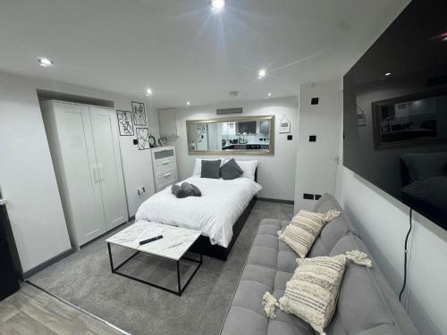 a bedroom with a bed and a couch at Royal Noor Escape in Killingbeck