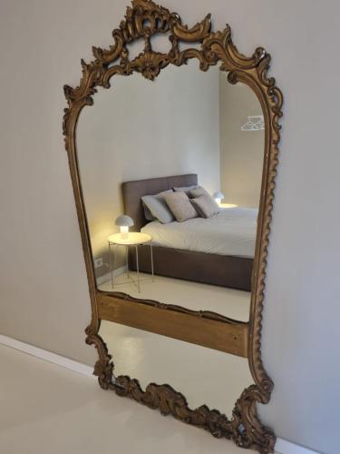 a large mirror with a bed in a bedroom at TM My Home in Novara