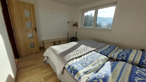 a bedroom with two beds and a window at apartmán Monte Lope in Bystřice pod Lopeníkem