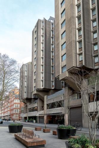 a large building with benches in front of it at STG Hotel Oxford Street - formerly St Giles London Hotel in London