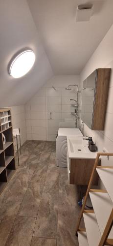 a kitchen with a sink and a counter in a room at Penthouse Vero I Bergblick I Seenähe I Hallstatt in Obertraun