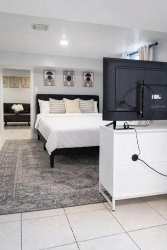 a bedroom with a bed and a flat screen tv at Modern Newark 1BR Apartment, Near Penn Station and EWR in Newark