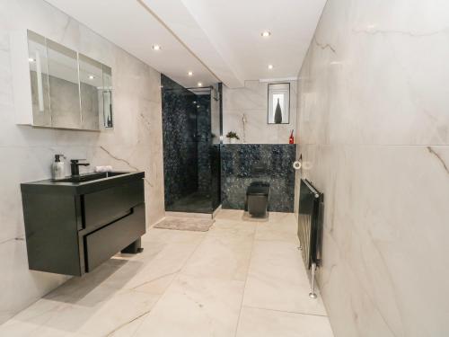 a bathroom with a sink and a toilet in it at 2 Manorhouse Farm in Rochdale