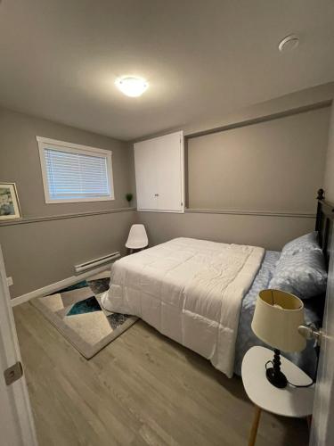 a bedroom with a bed and a table and a window at Federal Palace in Saskatoon