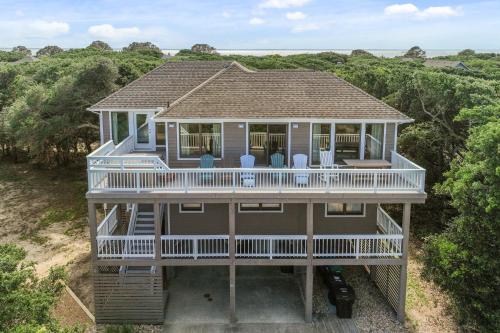 an aerial view of a house with a porch and chairs at 2444 - Sea Forever in Duck