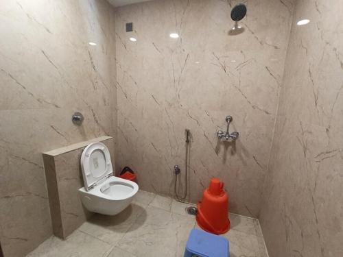a bathroom with a toilet and a shower at Hotel New M I Plaza in Gaya