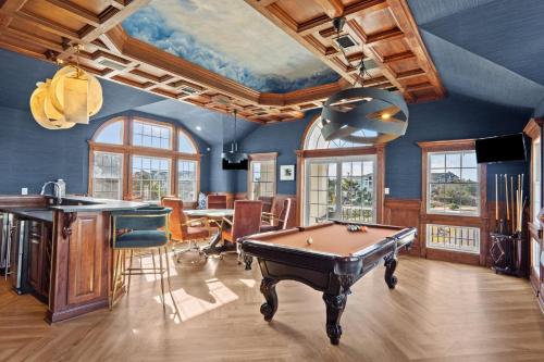 a living room with a pool table in it at 2876 - The Blue Martini in Duck