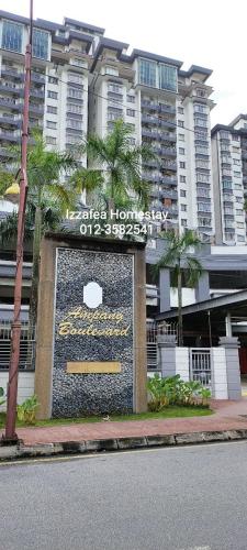 a sign in front of a building with palm trees at Izzafea Ampang KL in Ampang