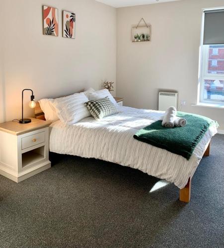 a bedroom with a bed with a teddy bear on it at 1BR Flat By Cozy Quarters Property Management Short Term Rental Hartlepool Near Marina Views in Hartlepool