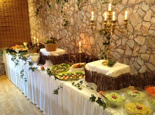 a buffet table with food on it with candles at AlmRefugio in Neumarkt in der Oberpfalz