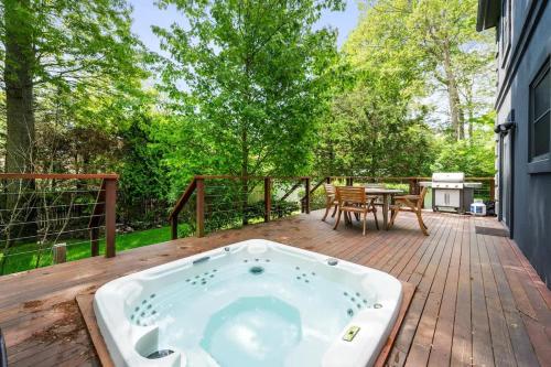 a jacuzzi tub sitting on a wooden deck at BlackBerry - Private home with Jacuzzi year-around in East Hampton