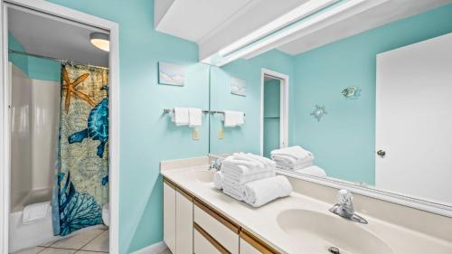 a bathroom with a sink and a mirror at Romar Tower 5C in Romar Beach