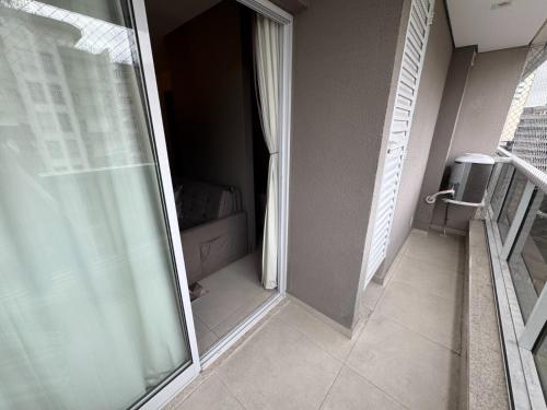 a bathroom with a glass door and a walk in shower at Studio completo com charme em ótima localização! in Juiz de Fora
