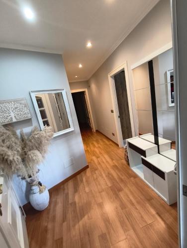 a living room with wooden floors and white walls at Curros in Ponte Do Porto